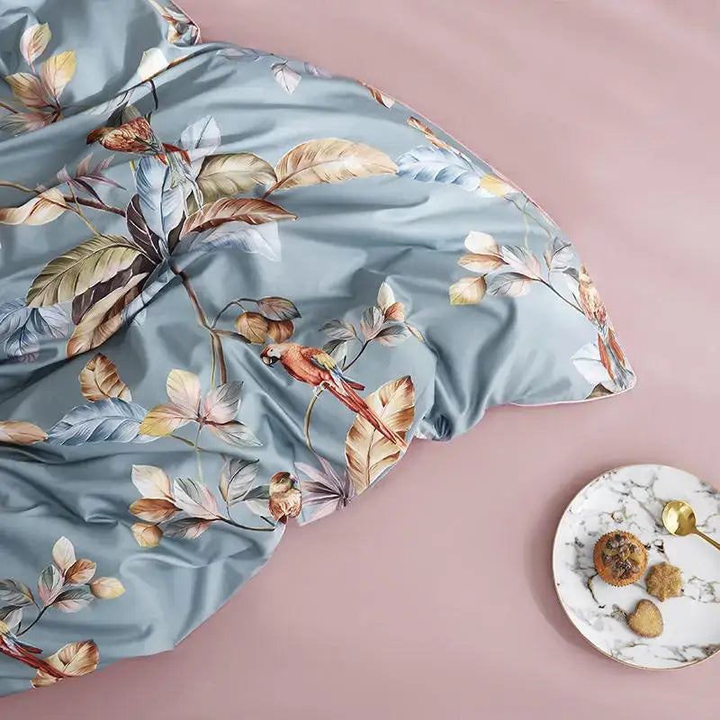 Light blue satin duvet cover with tropical leaves and vibrant red parrot made of Egyptian cotton by DecorBites™