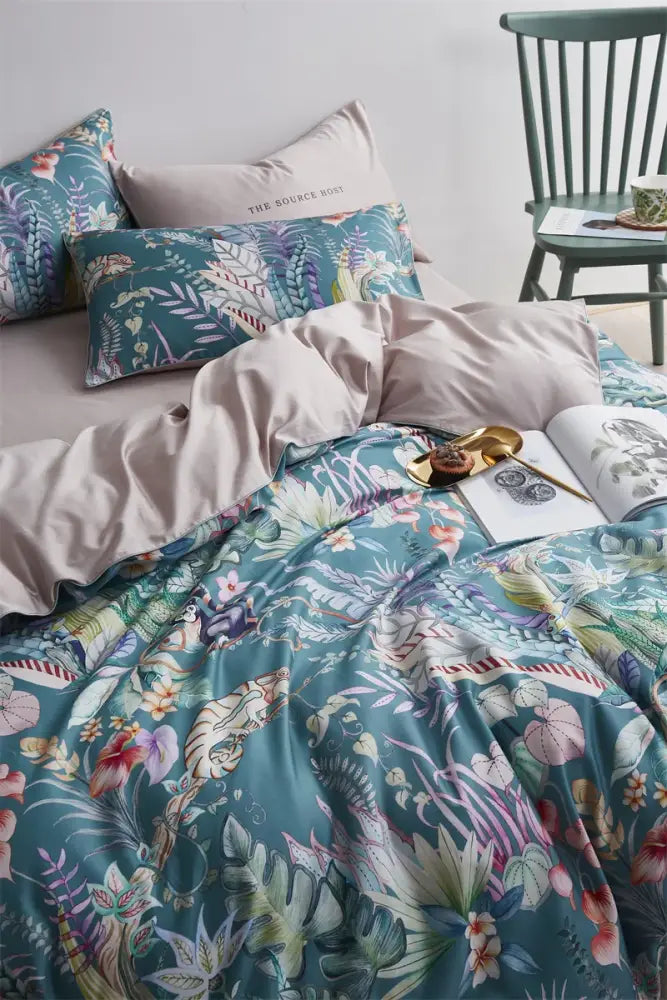 Teal satin duvet cover with vibrant tropical botanical print in pink and green in DecorBites luxury egyptian cotton set