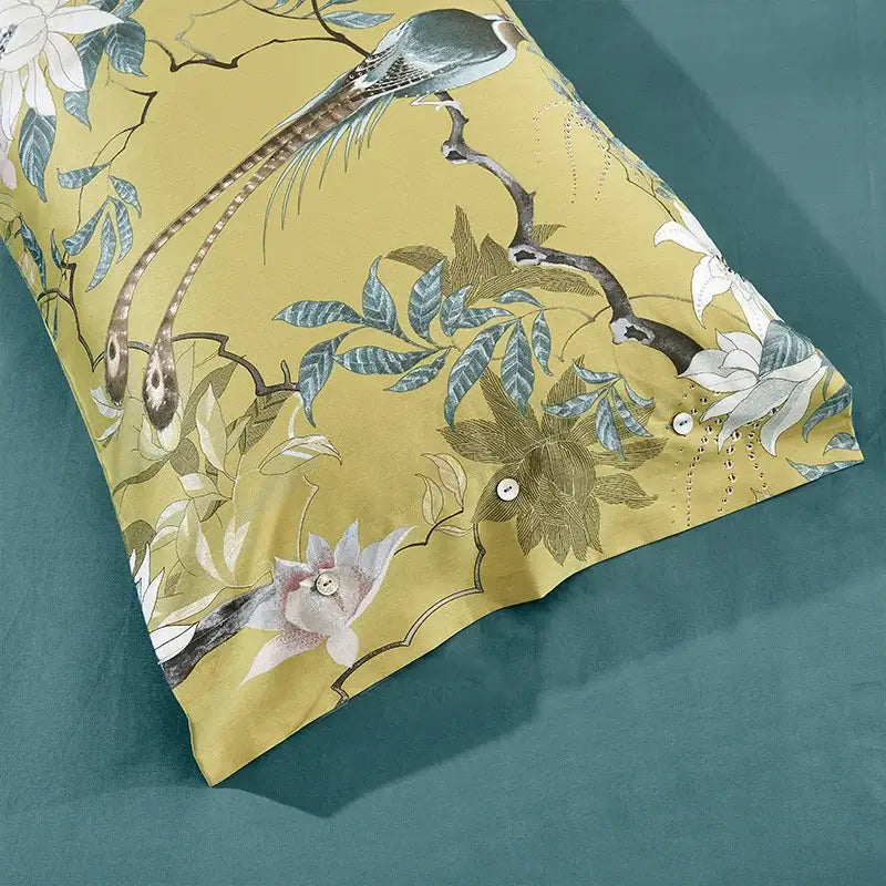 Yellow pillowcase from decorbites luxury egyptian cotton bedding set featuring elegant bird and floral pattern in muted blues whites and greens