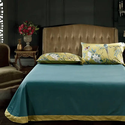 Teal satin duvet cover with gold trim and matching floral pieces pillowcases made of egyptian cotton in decorbites luxury set