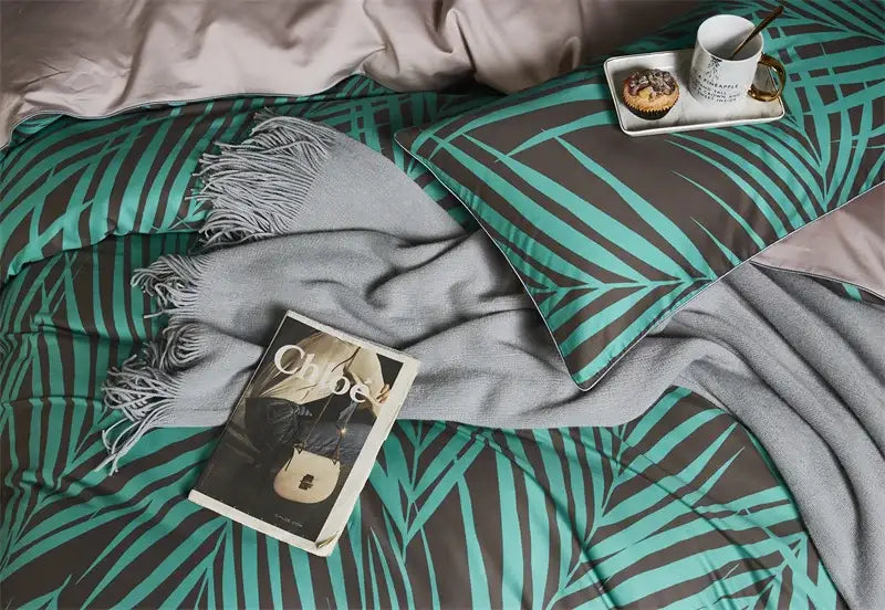 Decorbites luxury flamingo leaf duvet cover set with teal and dark gray palm leaf pattern and soft gray fringed throw blanket