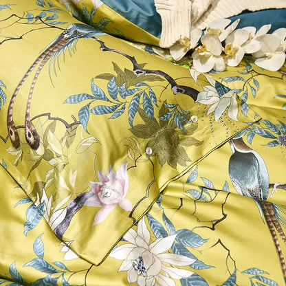 Vibrant yellow satin duvet cover with intricate blue green and white bird and blossom design includes pieces pillowcases 48*74cm