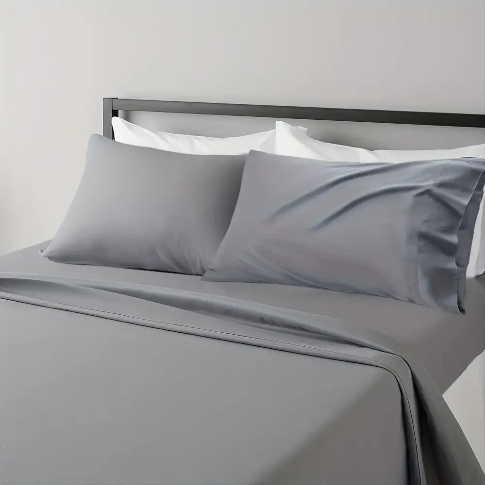 Gray satin pillowcases with a smooth glossy finish from the DecorBites™ luxury bed sheet set for hotel luxury comfort