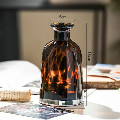 DecorBites luxury leopard glass vase in sleek amber with tortoiseshell pattern and reflective silver base for home decor