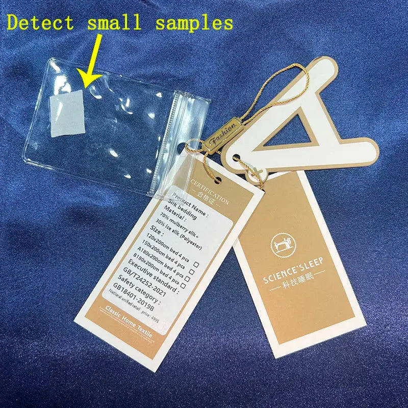 Clear plastic sample pouch with white label attached to beige and gold fabric tags on science sleep mulberry silk bedding set