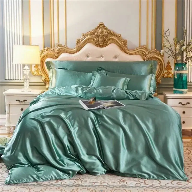 Luxurious teal mulberry silk bedding set with duvet cover and matching pillowcases on an ornate gold bed frame