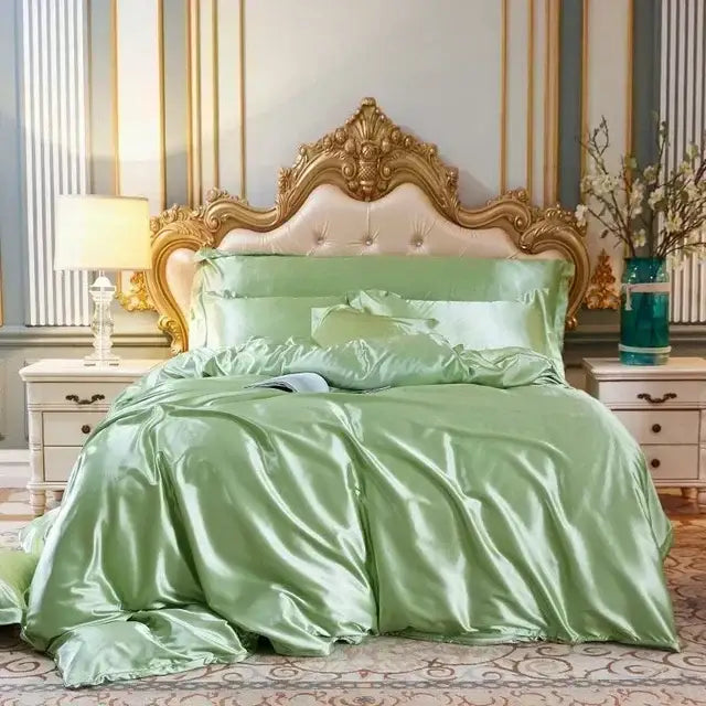 Luxurious sage green mulberry silk bedding set with duvet cover and pillowcase on ornate gold headboard by DecorBites