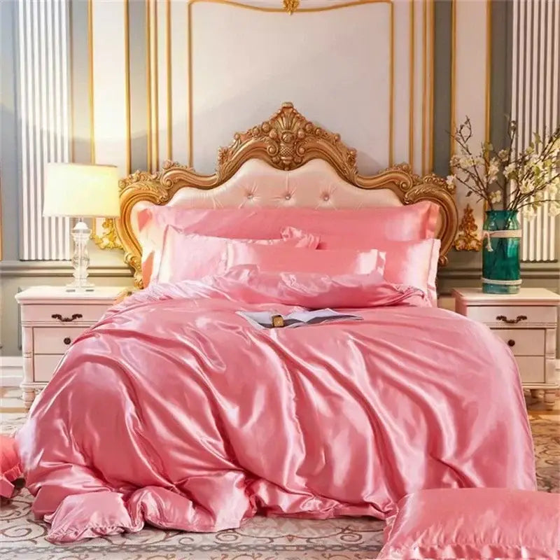 Pink satin mulberry silk bedding set with matching quilt pillows and ornate gold headboard by decorbites luxury