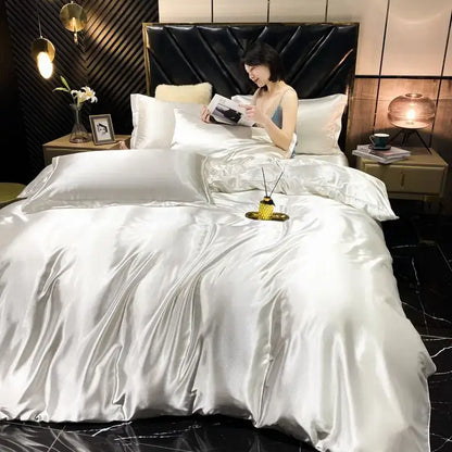 Shiny silver satin decorbites luxury silk bedding set with plush black headboard includes duvet cover and pillowcases