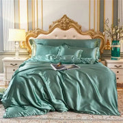 DecorBites™ luxury silk bedding set in teal satin with glossy finish and matching pillowcases on gold-framed bed