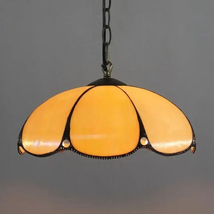 DecorBites™ luxury Tiffany style stained glass pendant light in warm amber with black metal frame and chain