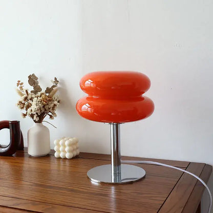 Vibrant orange glossy glass macaron lamp with sleek chrome base by italian designer italian designer table lamp