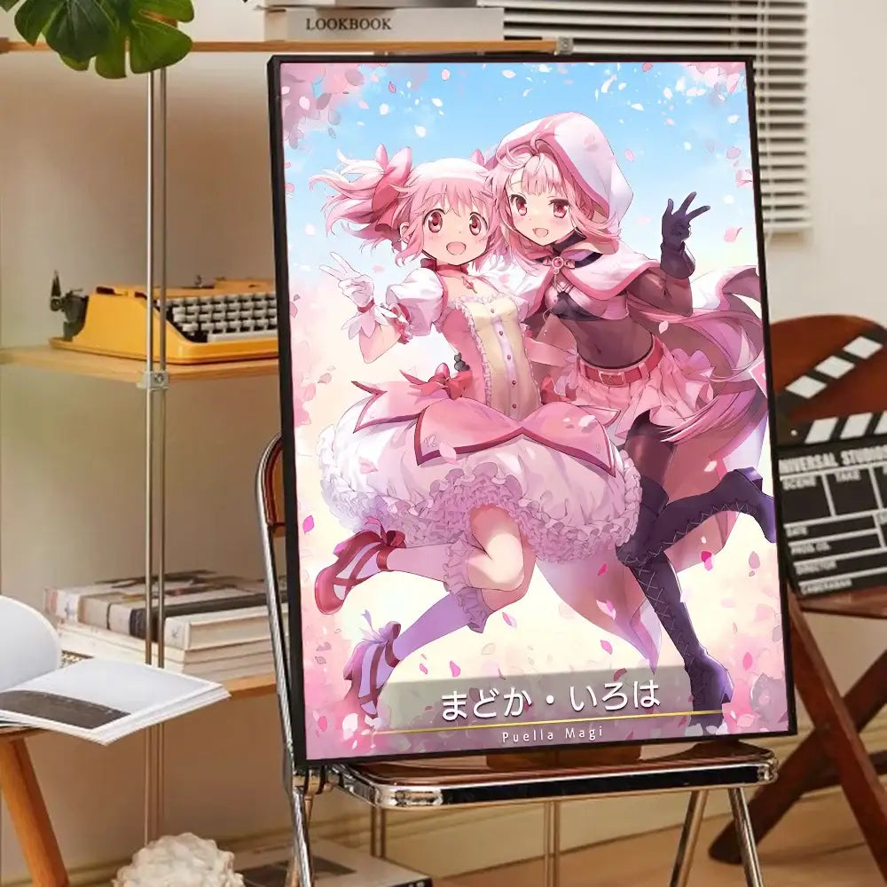 A framed madoka magica anime poster featuring two pink-haired puella magi madoka characters in elaborate dresses on a metal easel