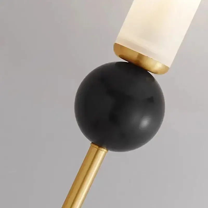 DecorBites marble sconce wall light with black marble sphere, gold metal accents, and frosted glass lampshade