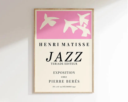 A framed matisse floral art print with pink bird silhouettes and black text on an off-white background from decorbites