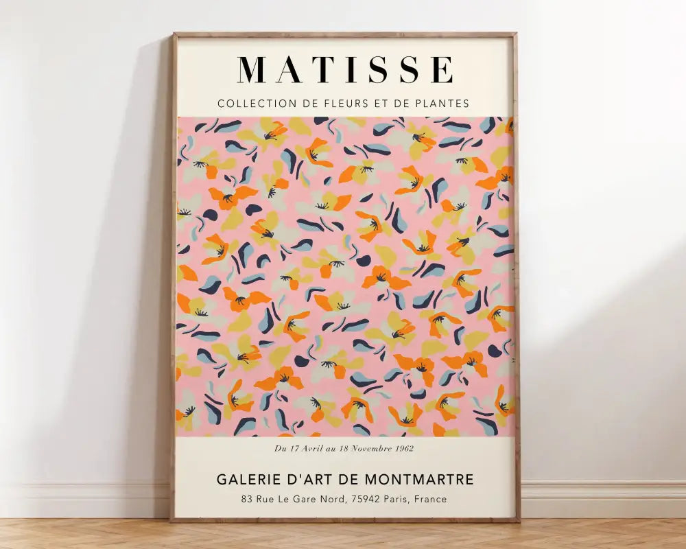 A framed abstract flowers canvas with vibrant matisse floral patterns in orange yellow and blue on soft pink background