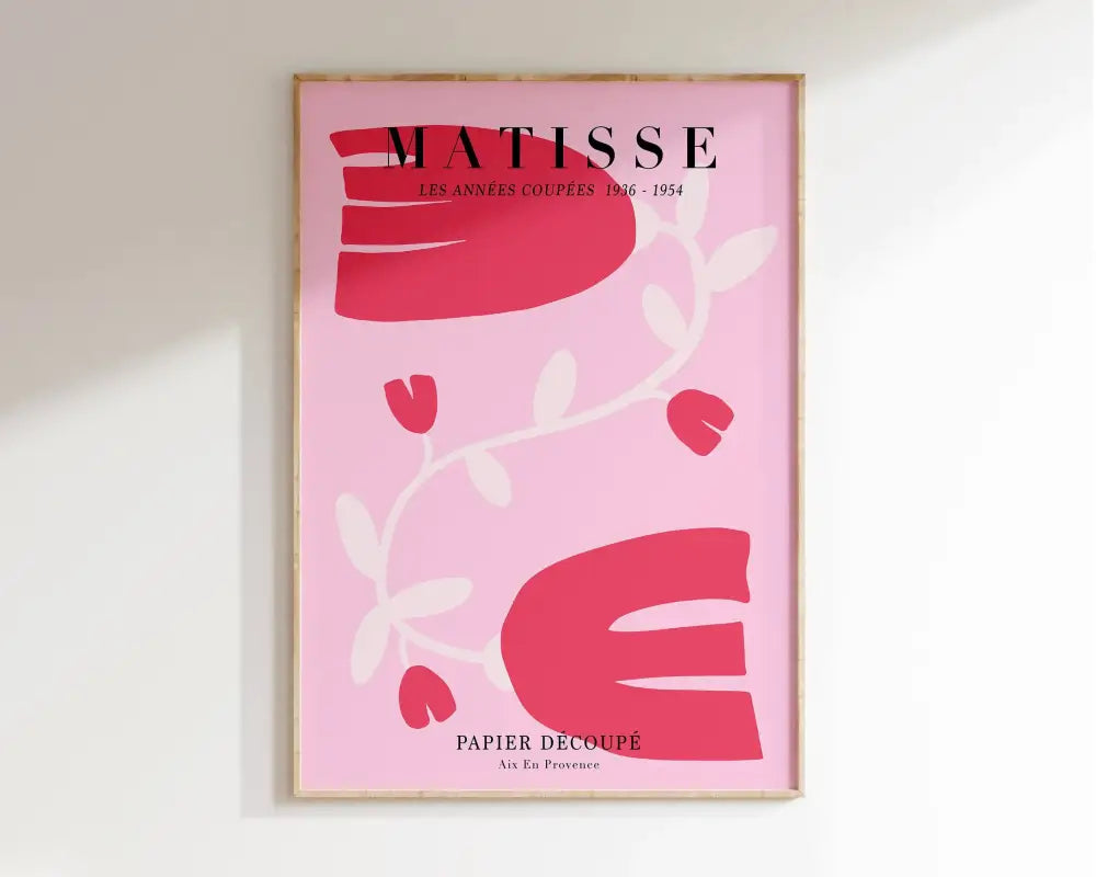 A framed matisse floral print featuring vibrant colors with bold red and white abstract shapes on pink paper-cut art