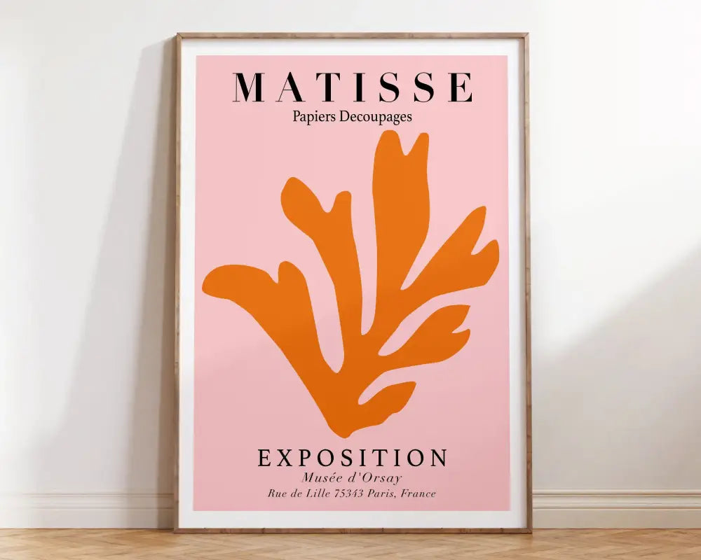 A framed decorbites matisse floral print featuring vibrant orange seaweed cutout on soft pink background with black text