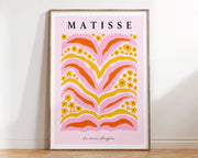 A framed decorbites™ matisse floral print featuring bold pink orange and yellow floral patterns on soft pink background