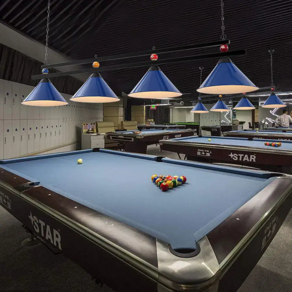 Blue felt pool table with dark brown wood frame and silver rails next to DecorBites metal hanging island light industrial pendant
