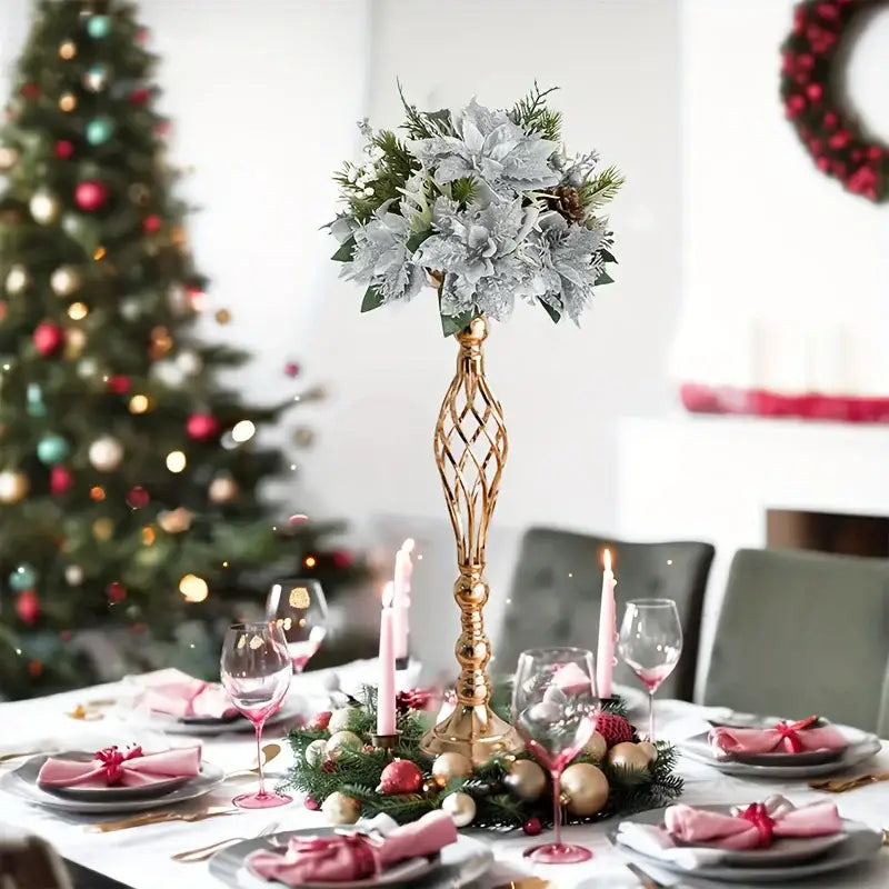 DecorBites metal vase set features a tall gold metal vase with twisted lattice design holding silver poinsettias and greenery