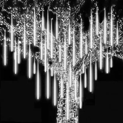 White led meteor shower string lights hanging from a tree for outdoor decor by DecorBites™