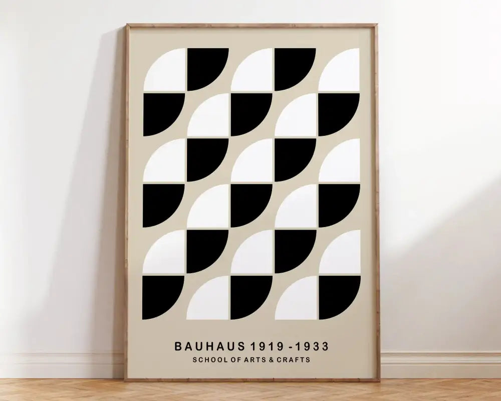 Minimalist mid century geometric canvas art with black and white semicircles on beige background in light wood frame