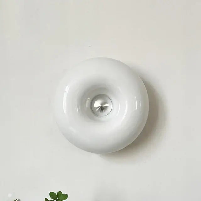 White glossy ceramic wall-mounted light fixture with central metallic accent for modern desk lamp decorbites bauhaus design