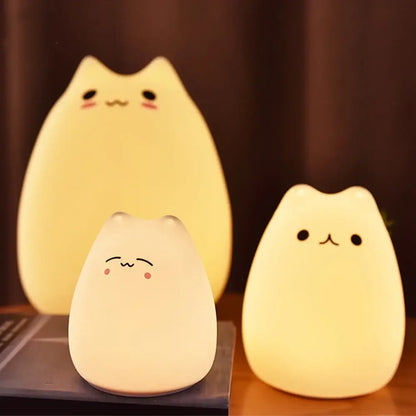 Three soft-glowing decorbites™ mini popular cat night lamps with blush pink cheeks and power switch for bedside use