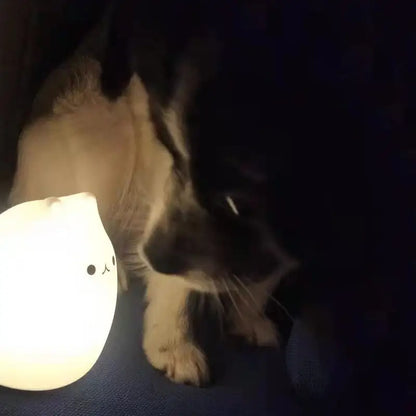 A soft glowing white mini popular cat night lamp with power switch and touch color-changing feature for bedside use