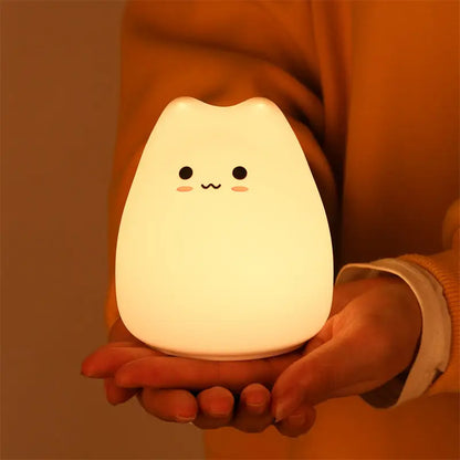 A soft white mini popular cat night lamp with a smiling face and power switch for bedside color-changing use