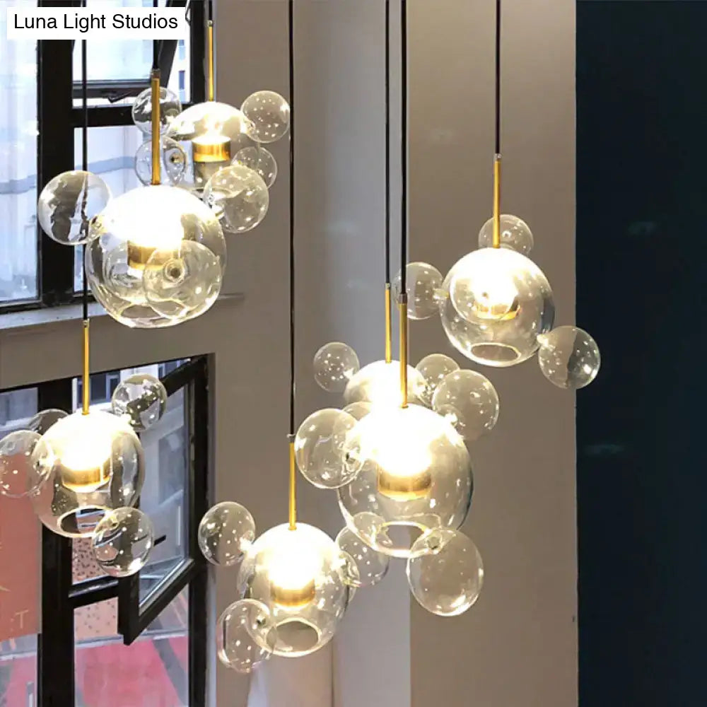 Decorbites™ minimal brass bubble pendant light featuring 5 clear glass heads with gold-toned metal accents in modern design