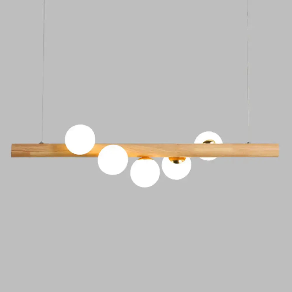 DecorBites minimalist cream glass LED ball island pendant light with natural wood bar and five frosted globe bulbs