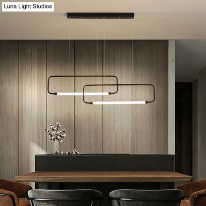 Modern black rectangular DecorBites™ LED pendant lights with minimalist design hang above a wooden dining room table