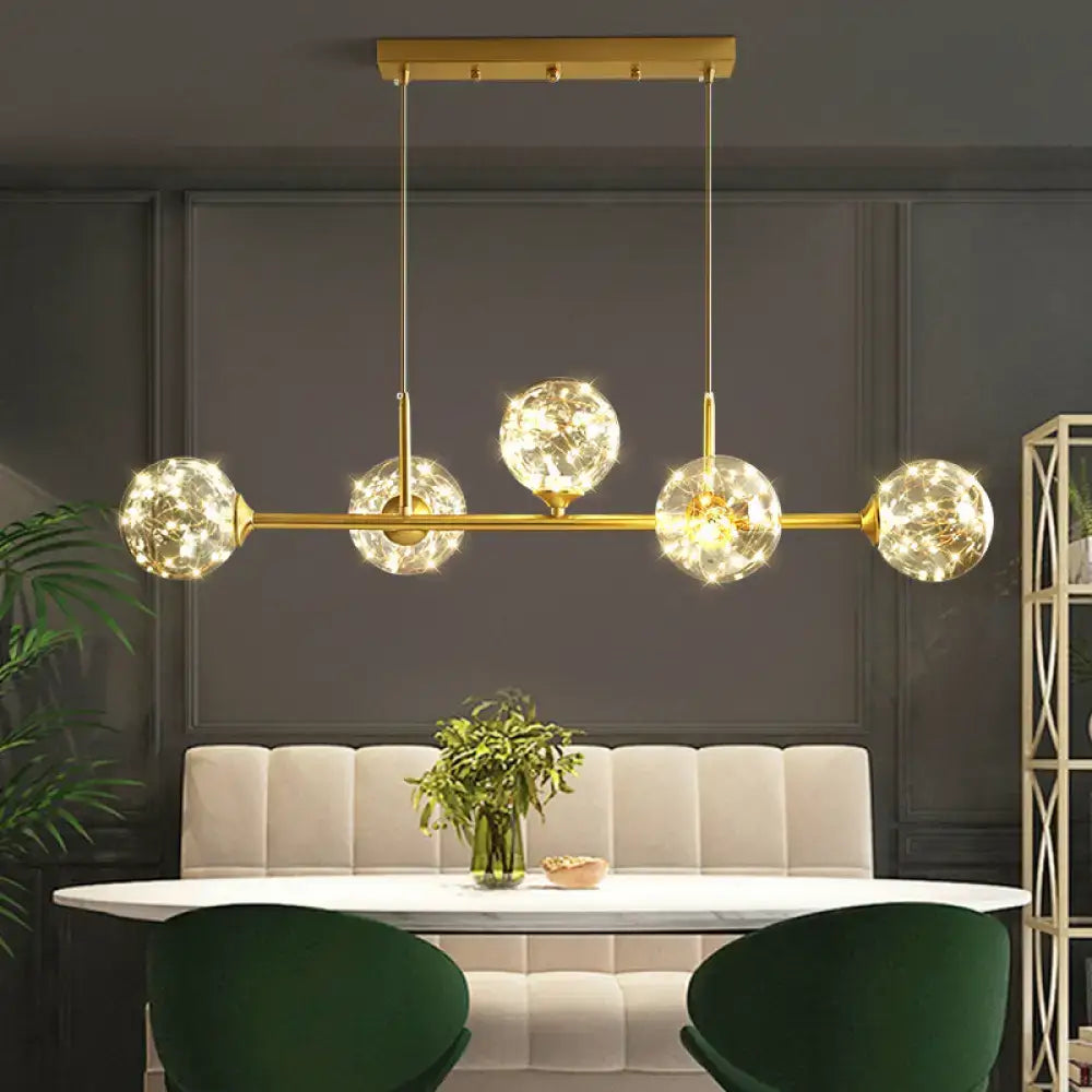 DecorBites™ gold-toned minimalist ceiling light with five clear glass sphere shades and brass finish LED pendant light