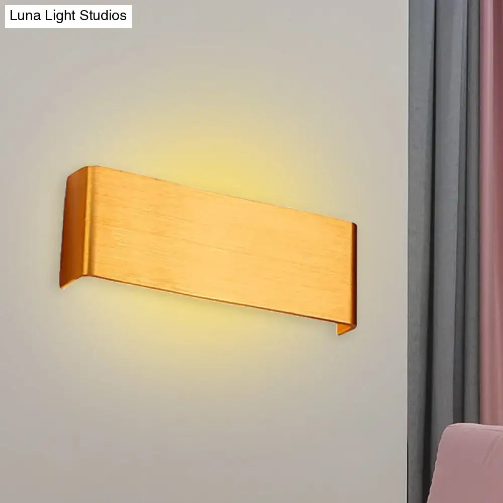Gold-finished rectangular wall lamp with sleek modern design providing warm white light for living room use