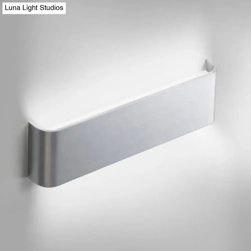 Minimalist black and silver wall lamp with brushed metal sides and white diffuser for living room warm white light