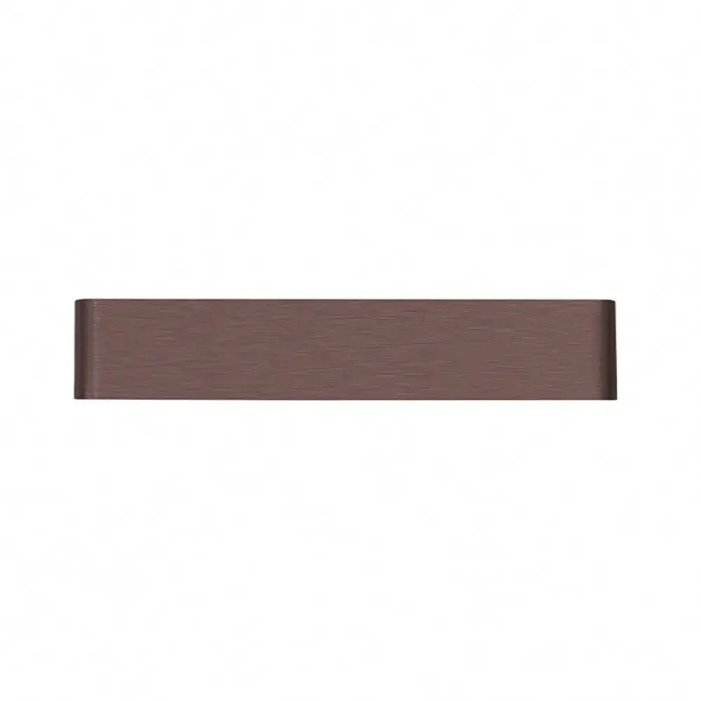 A sleek rectangular drawer pull with matte bronze finish complements a minimalist black and silver wall lamp for living room warm white light