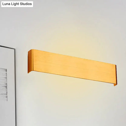 Gold-finished rectangular wall lamp with sleek modern design providing warm white light for living room use