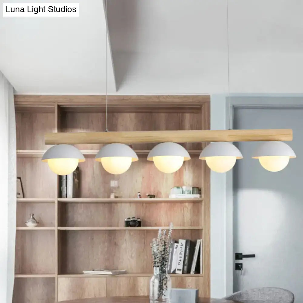 DecorBites™ minimalist wood island pendant with a long wooden bar and five grey dome-shaped shades