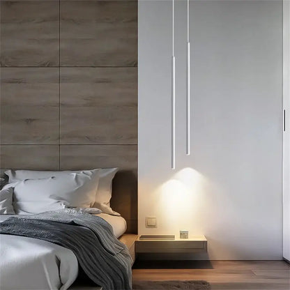 Minimalist white cylindrical decorbites™ modern 2cm led pendant lights hang above a floating nightstand casting warm illumination