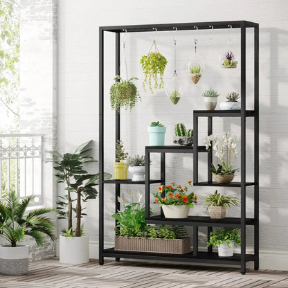 DecorBites™ modern black metal plant stand with five shelves and hanging hooks holding various potted plants