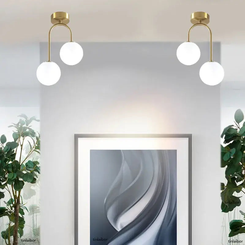 Gold-toned DecorBites™ modern acrylic ball ceiling light with two white spherical globes for home use