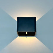 Black square modern battery operated wall sconce with sleek design and warm illumination by DecorBites™