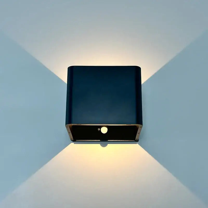 Black square modern battery operated wall sconce with sleek design and warm illumination by DecorBites™