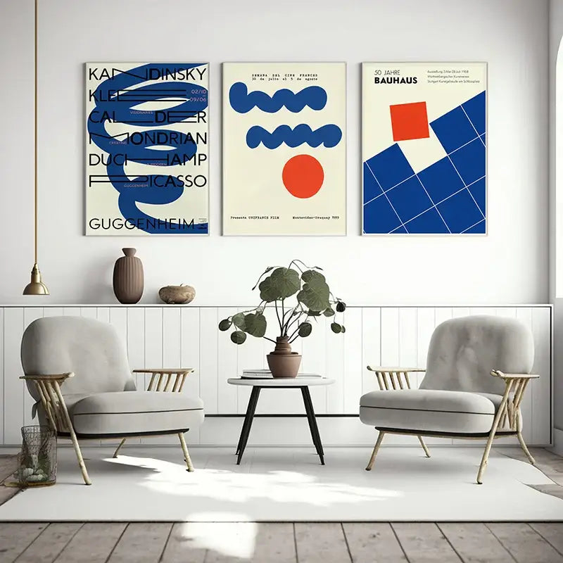 Three framed decorbites™ modern bauhaus exhibition posters with bold blue orange and black geometric designs on cream backgrounds