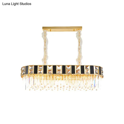 Gold-toned rectangular crystal oval island light with black and clear accents and 12 heads for dining room ceiling