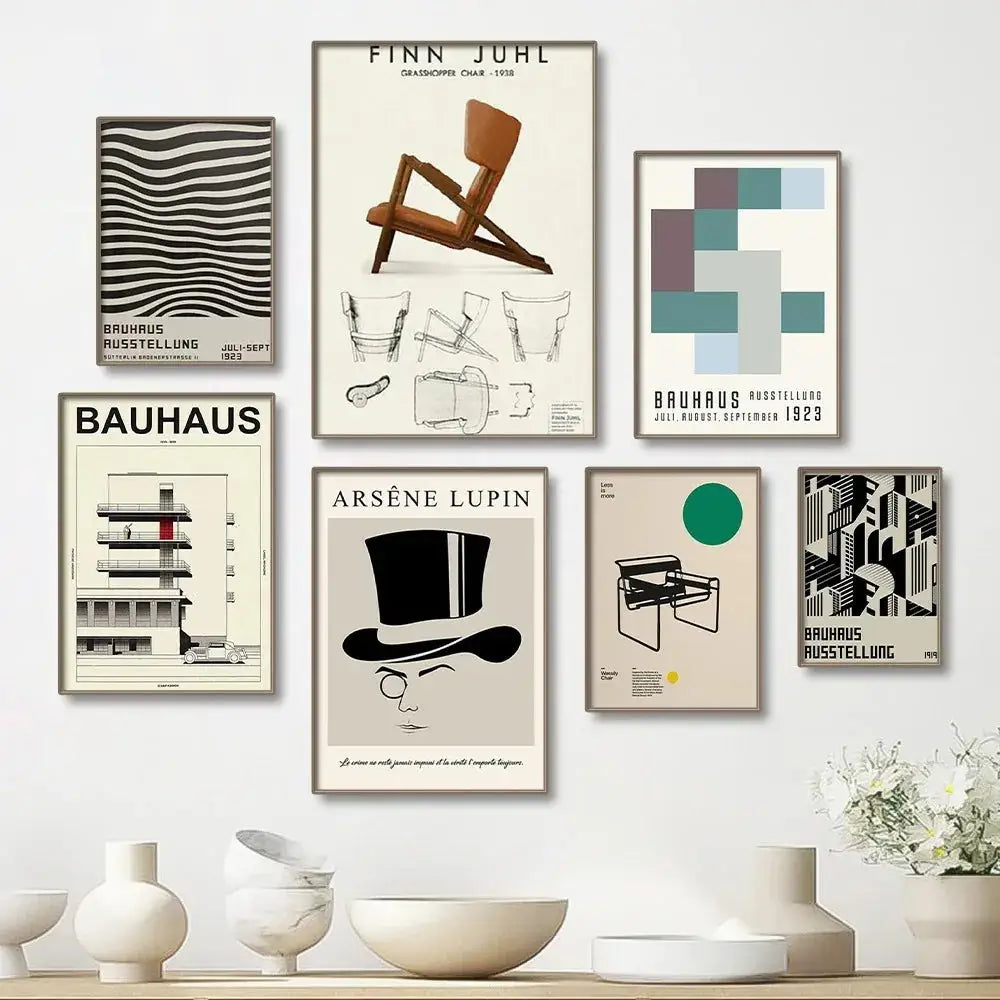 Beige wall with six framed modern black and white bauhaus canvas prints featuring bold typography and geometric designs