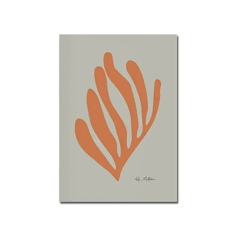 A minimalist notebook with a soft gray cover and orange abstract seaweed design next to a modern black and white bauhaus canvas print