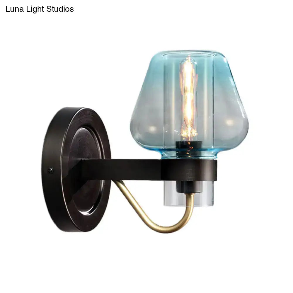 Modern blue glass wall sconce light fixture with tapered shade and brass accent arm for shade bedroom wall use